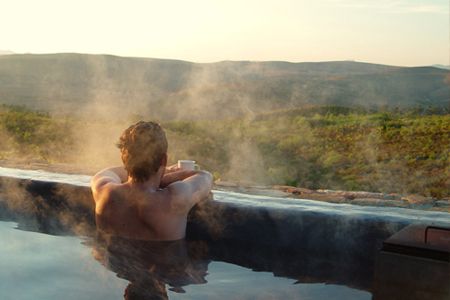 Where It All Began - Blog - Leave the city behind: 3 secluded mountain getaways near Cape Town - Man in Heated Pool Overlooking Beautiful View