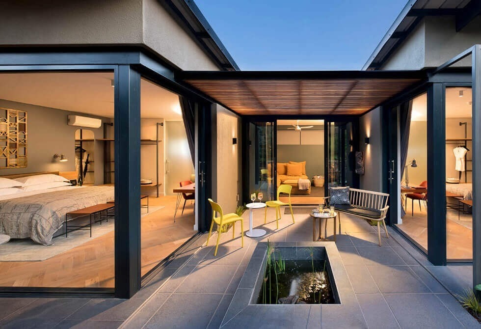 Where It All Began - Ethical Luxury Travel from Victoria Falls to Cape Town - Johannesburg - The Peech Hotel - Outside View Of Firepit and Bedrooms
