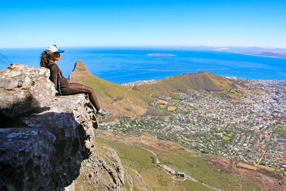 Where It All Began - Kwa-Zulu Natal and Western Cape Cycling Adventure - Table Mountain & Kirstenbosch Gardens - Woman on Mountain Edge