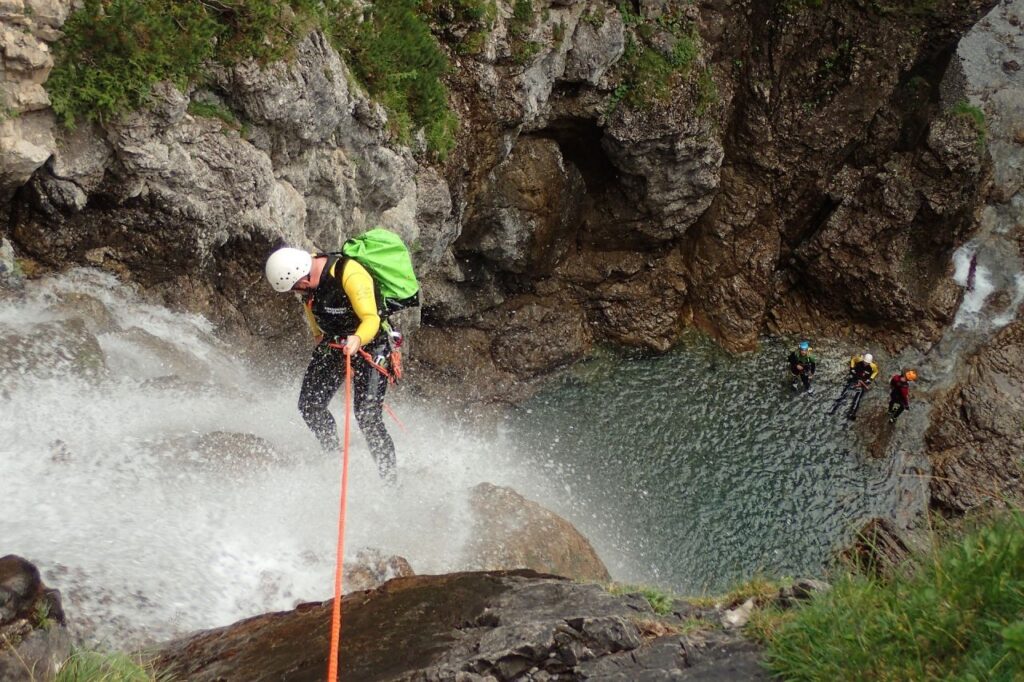 Where It All Began - Blog - “Kloofing” in South Africa: Dive into the Canyon Craze - Man Kloofing through Waterfall