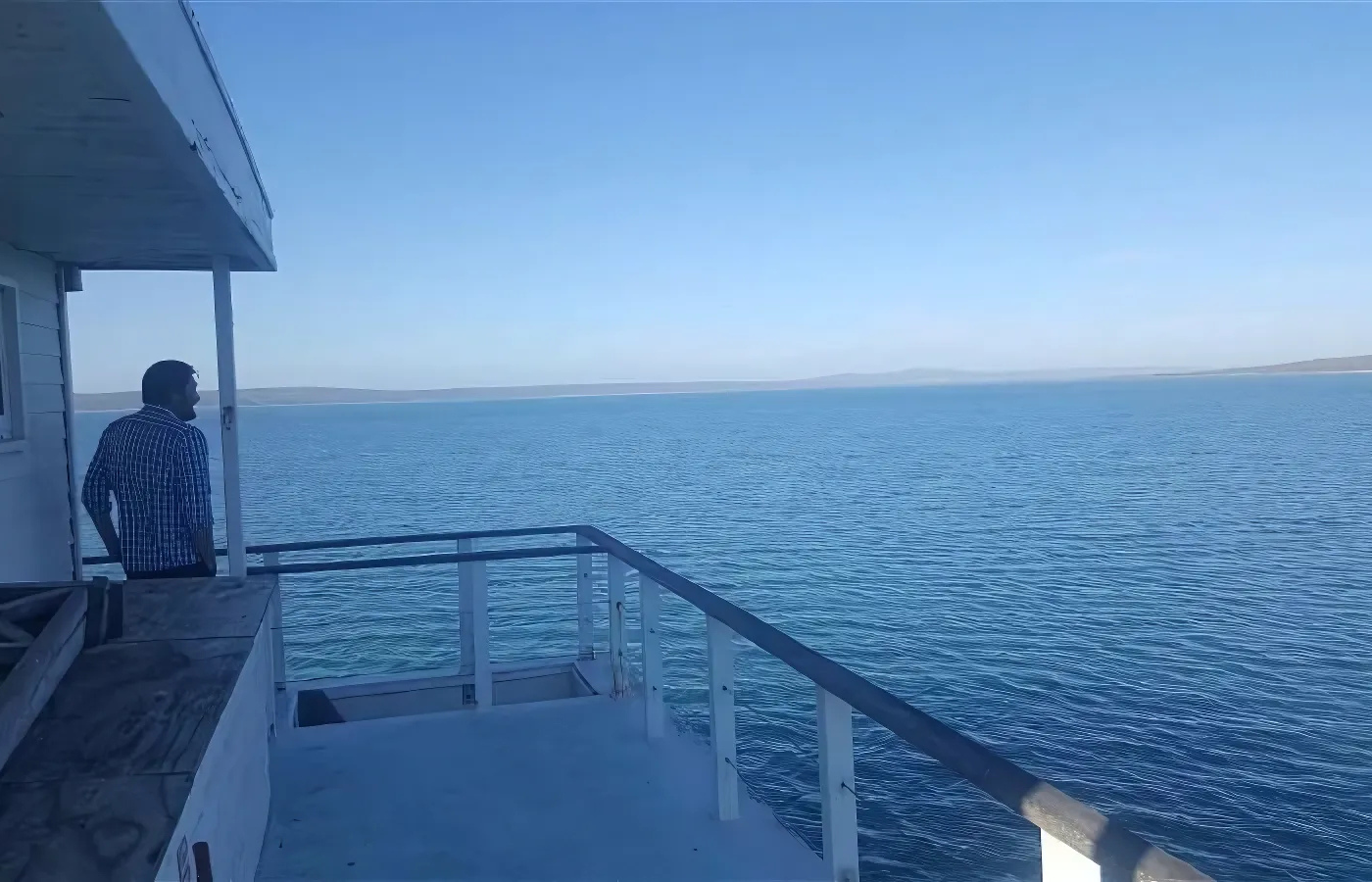 Where It All Began - Journeys - Kitesurfing & Houseboat Escape on the West Coast - Man Standing on Kraalbaai Boa House and Staring into Distance