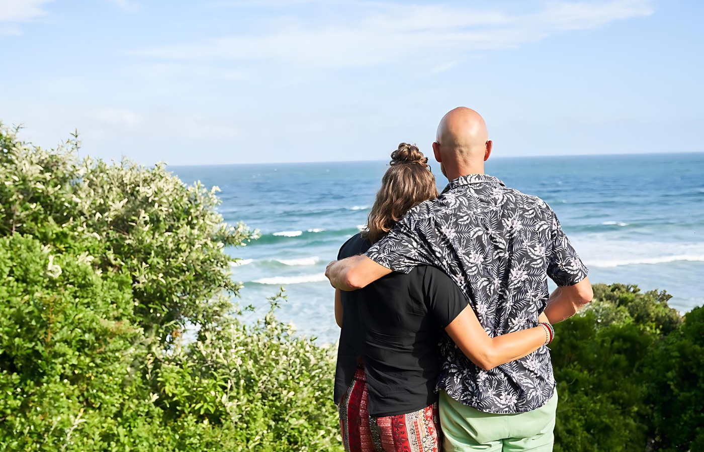 S052 - IT4 - Couple Admiring Beautiful Ocean View Where It All Began - Journeys - Wild Coast Hotel Hopper - Couple Admiring Beautiful Ocean View