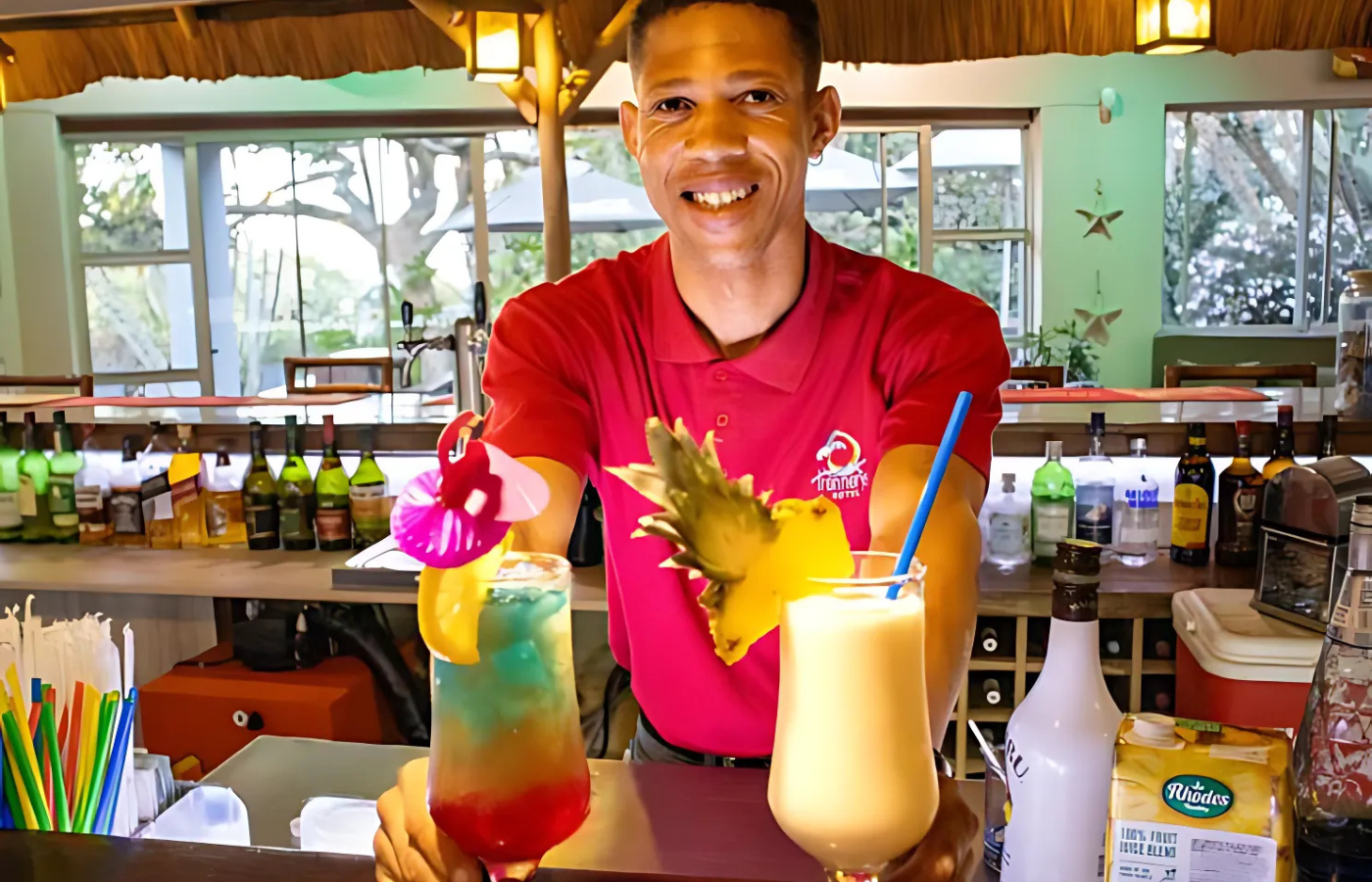 S052 - IT1 -  Bar Tender Serving Cocktails at Accommodation Bar Where It All Began - Journeys - Wild Coast Hotel Hopper - Bar Tender Serving Cocktails at Accommodation Bar