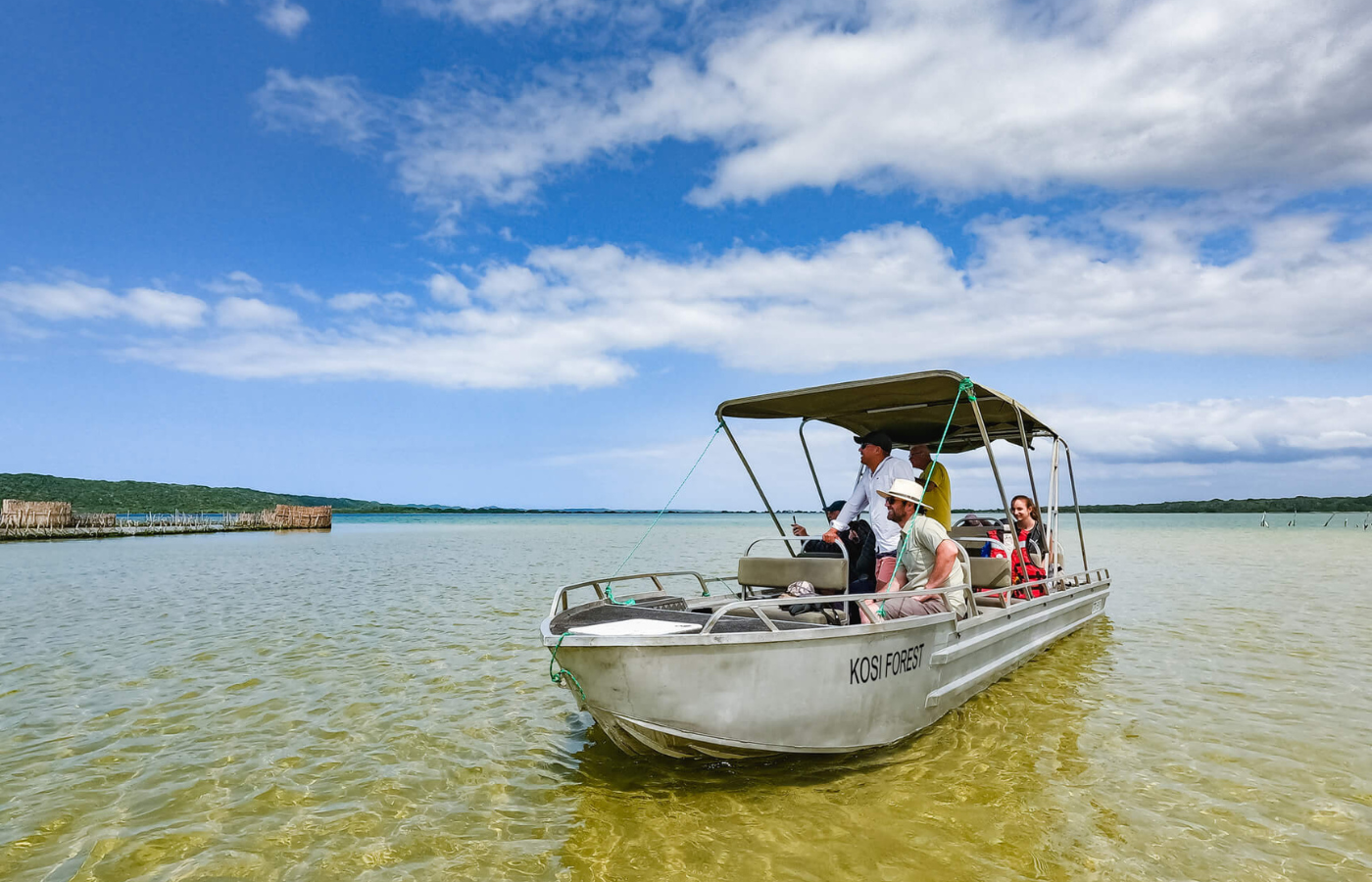 S050 - IT2 - Tourists on Boat Trip in Lake Near Accommodation Where It All Began - Journeys - Tropical African Lake and Forrest Slackpacking Adventure - Tourists on Boat Trip in Lake Near Accommodation