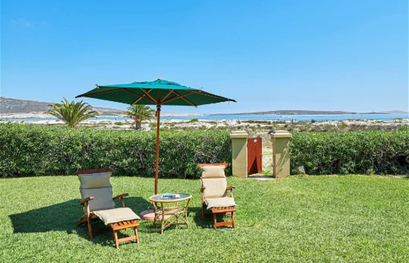 Where It All Began - Journeys - Catamaran Sailing in South Africa - Chairs and Sun Umbrella at Accommodation with Ocean Background