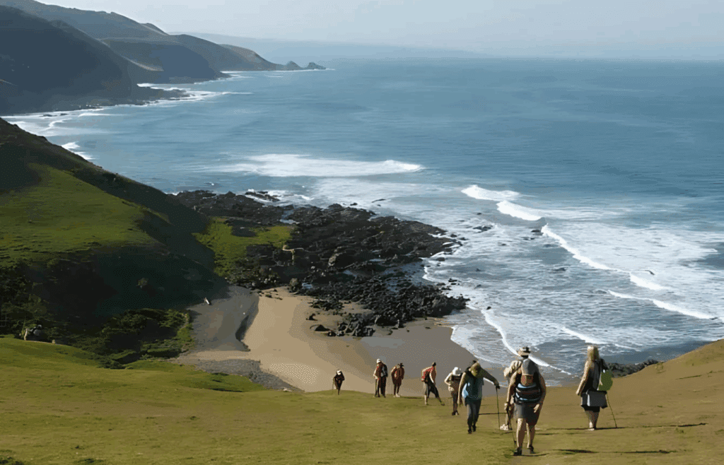 Where It All Began - Journeys - Wild Coast Hotel Hopper - Beach Hike Heading Uphill and Beautiful Ocean Background