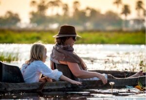 Where It All Began - Namibia & Okavango 4x4 Self Drive African Safari - Okavango - Delta Camp - Mom and Daughter on River Raft | Where It All Began - Namibia & Okavango Overlanding 4x4 Adventure - Okavango Delta - Delta Camp - Mom and Daughter on River Raft